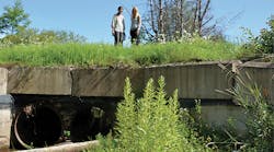 This 2016 photo shows the old culvert, which had two circular pipes with a total diameter of 36 inches. Pictured are Rifat Salim (left) and JoAnne Castagna.