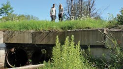 This 2016 photo shows the old culvert, which had two circular pipes with a total diameter of 36 inches. Pictured are Rifat Salim (left) and JoAnne Castagna.