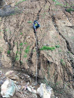 Robert Leeper is shown barely able to sit in a rill while taking measurements during field reconnaissance in the Las Lomas watershed. The image was taken on December 24, 2016, following a series of moderate to intense rainstorms over the burn area. Robert Leeper is shown barely able to sit in a rill while taking measurements during field reconnaissance in the Las Lomas watershed. The image was taken on December 24, 2016, following a series of moderate to intense rainstorms over the burn area.