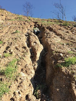 Robert Leeper is shown comfortably sitting in the same location as seen in the previous photo. The image was taken on January 16, 2017. The rill has increased in width and depth due to erosion during a series of moderate to intense rainstorms. Topographic changes as seen in the hillslope are detectable and measurable utilizing high resolution UAS-derived imagery and photogrammetric processing and modeling. Robert Leeper is shown comfortably sitting in the same location as seen in the previous photo. The image was taken on January 16, 2017. The rill has increased in width and depth due to erosion during a series of moderate to intense rainstorms. Topographic changes as seen in the hillslope are detectable and measurable utilizing high resolution UAS-derived imagery and photogrammetric processing and modeling.