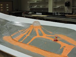 A 1:84 scale hydraulic model of the volcano erupting at a 100-year design flow.