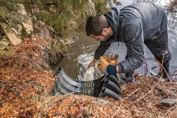 Corey Laxson collecting a stormwater runoff sample on Mirror Lake. Corey Laxson collecting a stormwater runoff sample on Mirror Lake.