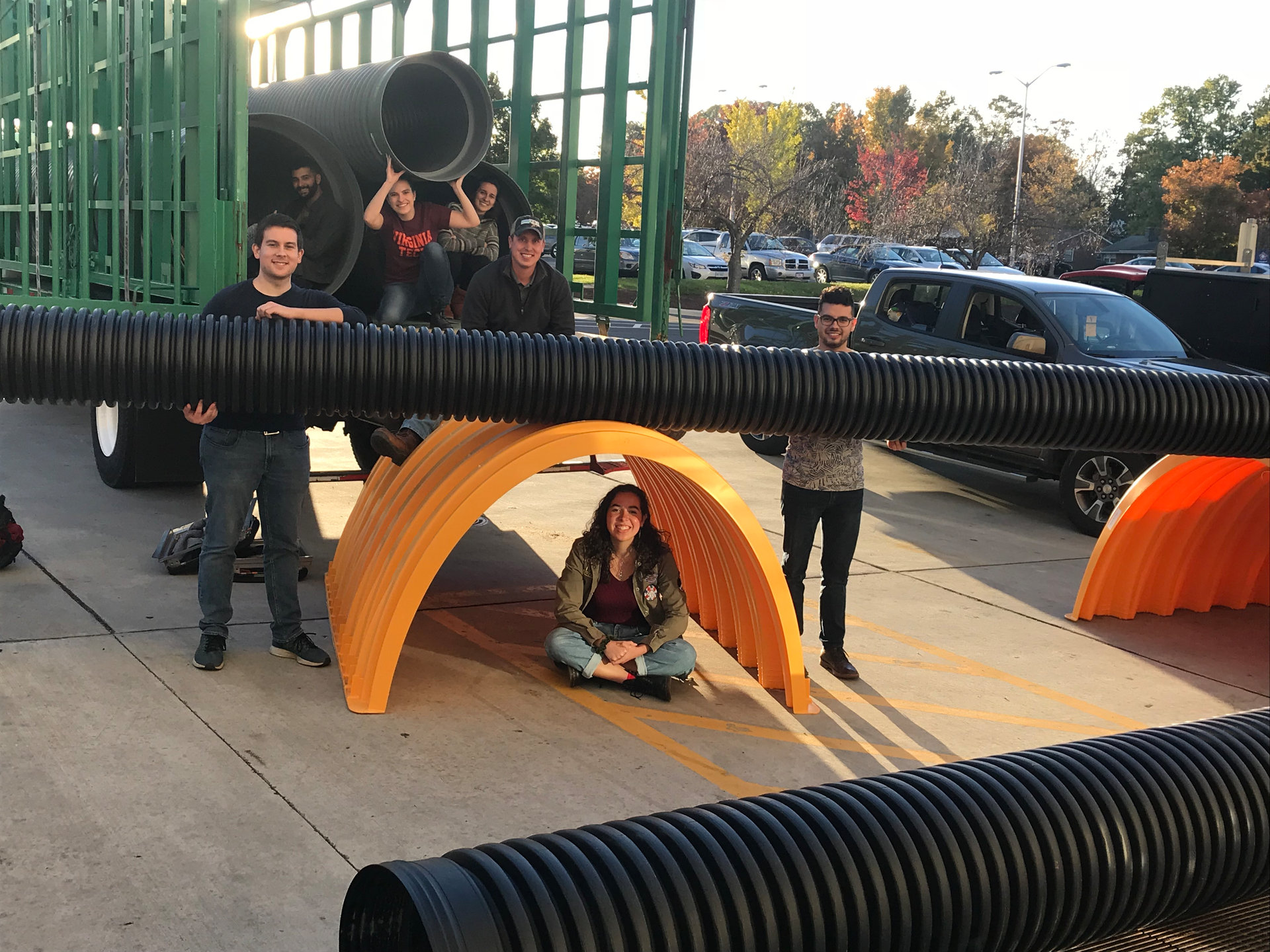 Virginia Tech students pose with Advanced Drainage Systems' stormwater management products during an on-site exhibition at the school.