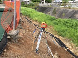 Figure 1 B. Stream channel showing concrete lining on western bank and erosion impacts on residential property along the stream bank. Figure 1 B. Stream channel showing concrete lining on western bank and erosion impacts on residential property along the stream bank.