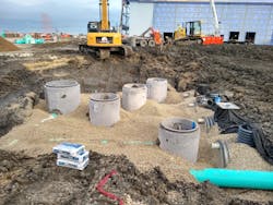 Installation of the system. The ends of the buried storage tanks can be seen on the right. Installation of the system. The ends of the buried storage tanks can be seen on the right.