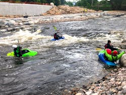 Kayakers enjoying the finished whitewater park Kayakers enjoying the finished whitewater park