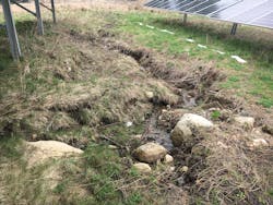 Eroded channel caused by concentrated stormwater flow before site vegetation was able to be established. Eroded channel caused by concentrated stormwater flow before site vegetation was able to be established.