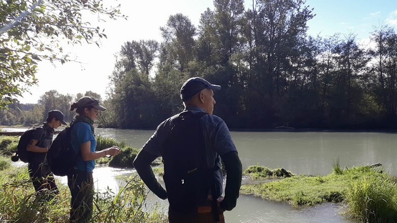 Staff from Nisqually Land Trust inspect a site along the Nisqually River. This site is part of a project supported by the 2019 grant round.