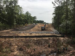 A stabilized access road, temporary seed and mulch, and aggregate and silt fence barriers provide protection for this area of limited clearing required for future bridge construction. A stabilized access road, temporary seed and mulch, and aggregate and silt fence barriers provide protection for this area of limited clearing required for future bridge construction.