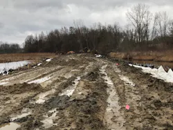 Due to warmer than usual winter conditions, the ground did not freeze, which made navigating the muddy conditions challenging for construction equipment.