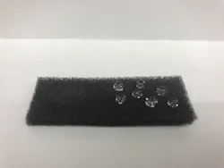 The OHM sponge is oleophilic and hydrophobic. On the left side of the sponge, oil was applied and quickly absorbed. On the right side, the sponge repels water droplets.