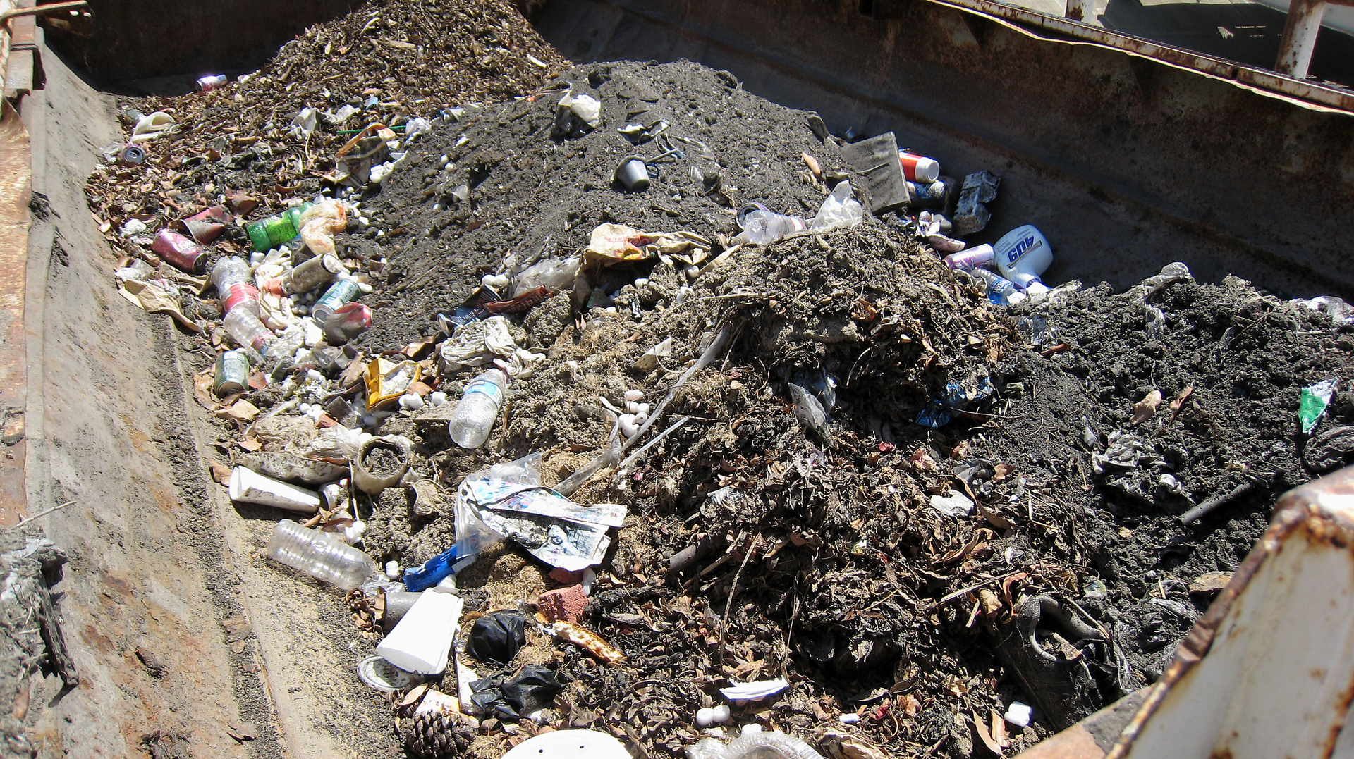 Litter captured by Ultra-Drain Guard disposed of properly in dumpster.