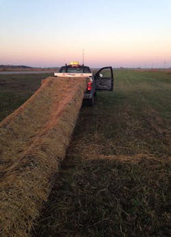 Minnesota DOT crews install a linear piece of biodegradable erosion control matting.