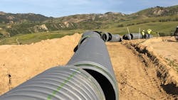 Large diameter stormwater pipe is staged and ready to be installed in the trench at Porter Ranch. Large diameter stormwater pipe is staged and ready to be installed in the trench at Porter Ranch.