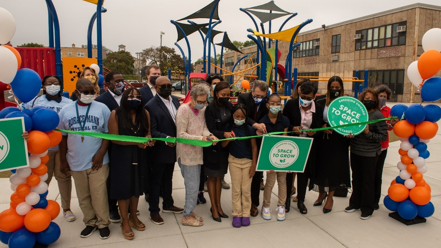 Officials, stakeholders and students at Mann Elementary School cut the ribbon on the new green schoolyard.