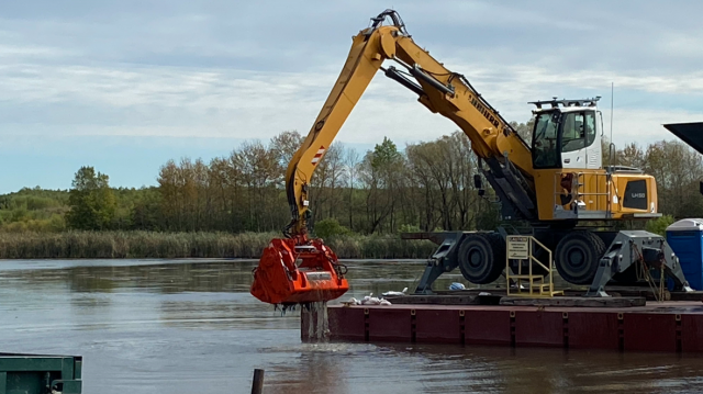 Mechanical dredging of contaminated sediment in the East Pond.