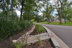 One neighborhood’s GI installation in Hinsdale, Ill., featuring a curb cut to drain stormwater into the adjacent rain garden. One neighborhood’s GI installation in Hinsdale, Ill., featuring a curb cut to drain stormwater into the adjacent rain garden.