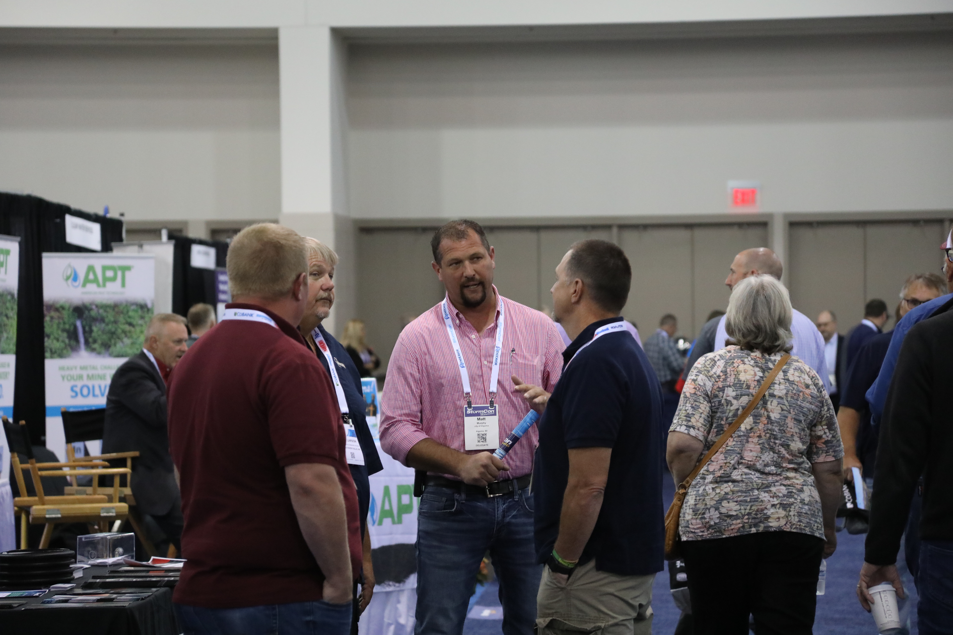 StormCon attendees share a conversation on the show floor.
