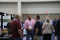 StormCon attendees share a conversation on the show floor.