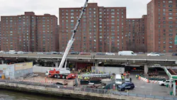 A 197-foot-tall Liebherr LTM 1130 crane prepares to lift the first 32,000-pound flood gate into place as part of East Side Coastal Resiliency. A 197-foot-tall Liebherr LTM 1130 crane prepares to lift the first 32,000-pound flood gate into place as part of East Side Coastal Resiliency.