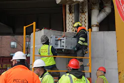 Workers install one of the huge hinges that will anchor the 16-ton flood gate. Workers install one of the huge hinges that will anchor the 16-ton flood gate.