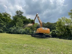 Nearly 80 feet from bank to bank and 35 feet down the slope meant the ditch was practically impossible to work on without a machine capable of reaching over 60 feet.