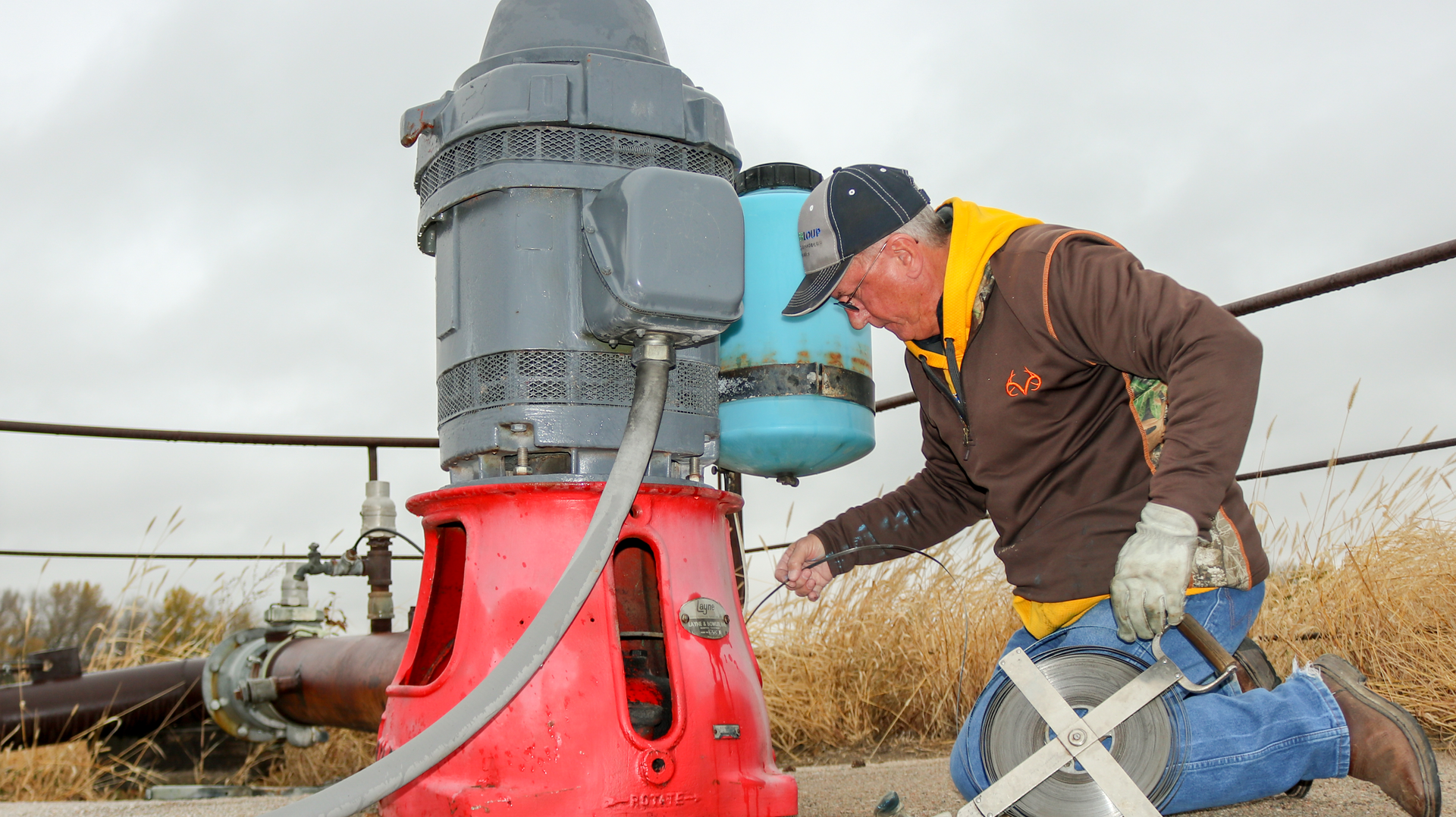 Nebraska's Natural Resources Districts have continued to work on vital water conservation since 1972. Here, Natural Resources Technician Dan Ray measures the static level of an irrigation well in Greeley County, Neb., after harvest.