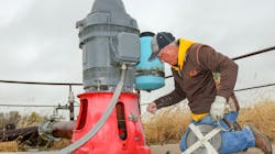 Nebraska's Natural Resources Districts have continued to work on vital water conservation since 1972. Here, Natural Resources Technician Dan Ray measures the static level of an irrigation well in Greeley County, Neb., after harvest. Nebraska's Natural Resources Districts have continued to work on vital water conservation since 1972. Here, Natural Resources Technician Dan Ray measures the static level of an irrigation well in Greeley County, Neb., after harvest.