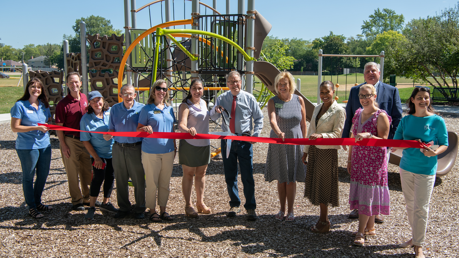 Officials, staff, and village trustees formally unveiled the new Aspen Trails Park.