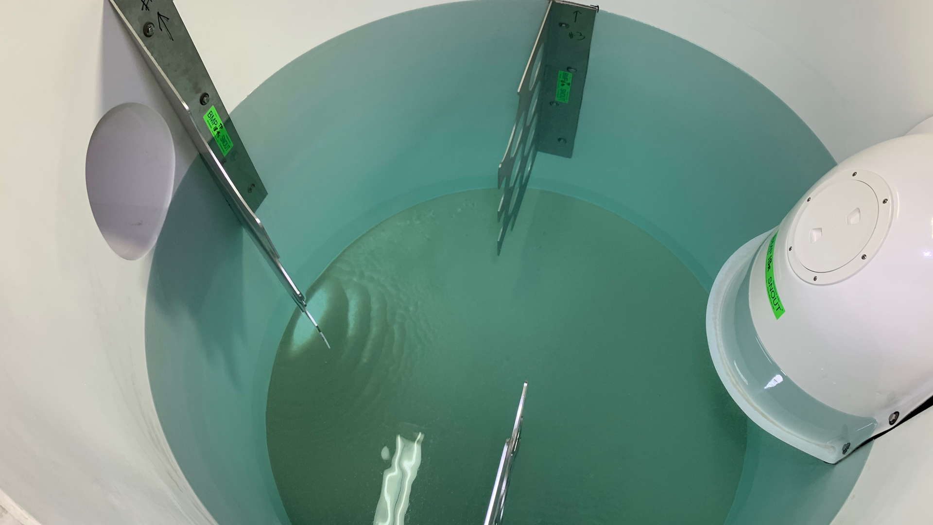 A combination of a solid baffle and perforated baffles helps redirect flow and increase the length of the surface that the flow needs to travel.