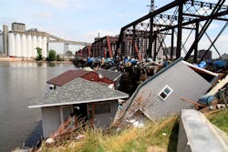 In the aftermath of the Iowa Flood of 2008, houses washed up against the Cedar Rapids railroad bridge.