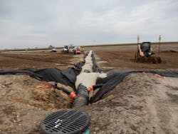 The 24-inch diameter HDPE collector pipe spans the length of the infield.