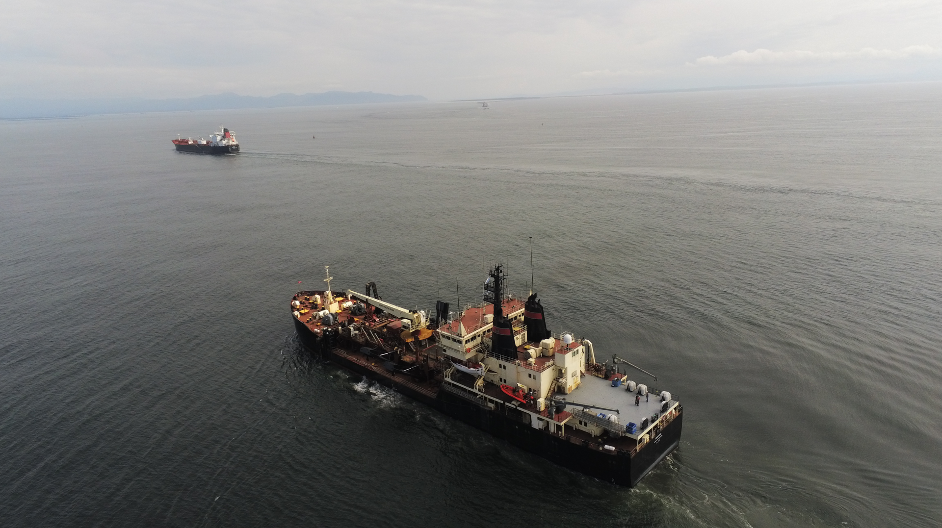 These two dredging vessels dredge the 2-4 million cubic meters annually from the six-mile-long channel.