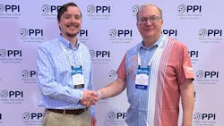 Patrick Vibien (right), P.Eng., director of engineering of the PPI&rsquo;s Power &amp; Communications Division congratulates Christian Herrild (left) of Teel Plastics for being named Member of the Year for the division.