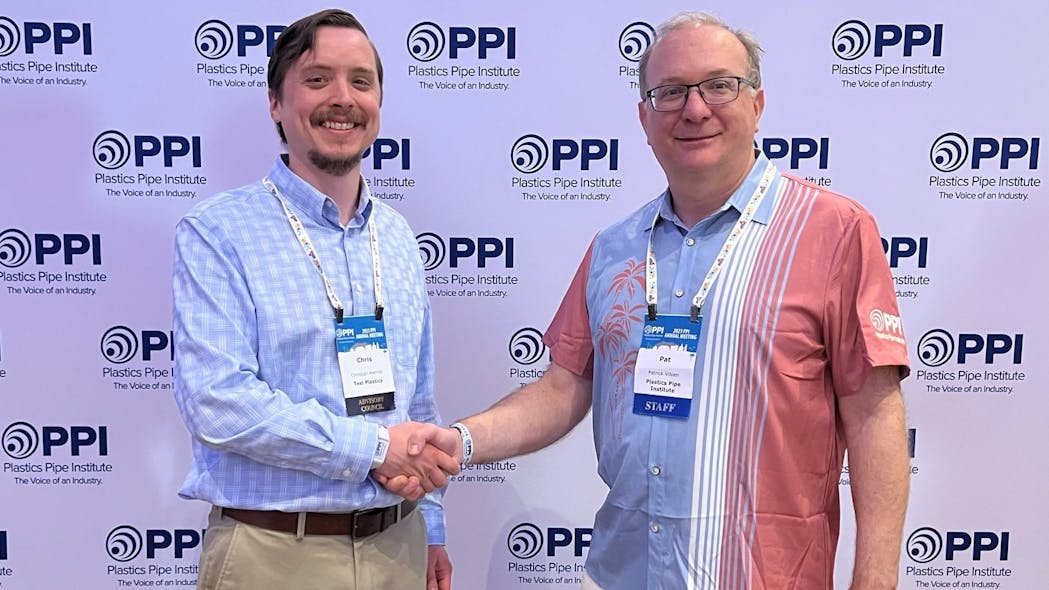 Patrick Vibien (right), P.Eng., director of engineering of the PPI&rsquo;s Power &amp; Communications Division congratulates Christian Herrild (left) of Teel Plastics for being named Member of the Year for the division.