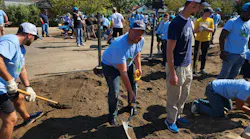 MWRD Commissioner Daniel Pogorzelski shovels soil during the construction of the O.A. Thorps Scholastic Academy rain garden.