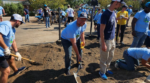MWRD Commissioner Daniel Pogorzelski shovels soil during the construction of the O.A. Thorps Scholastic Academy rain garden.