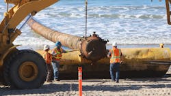 Crews from USACE contractor, Manson Construction, prepare to remove beach end of massive sand pipeline. Crews from USACE contractor, Manson Construction, prepare to remove beach end of massive sand pipeline.
