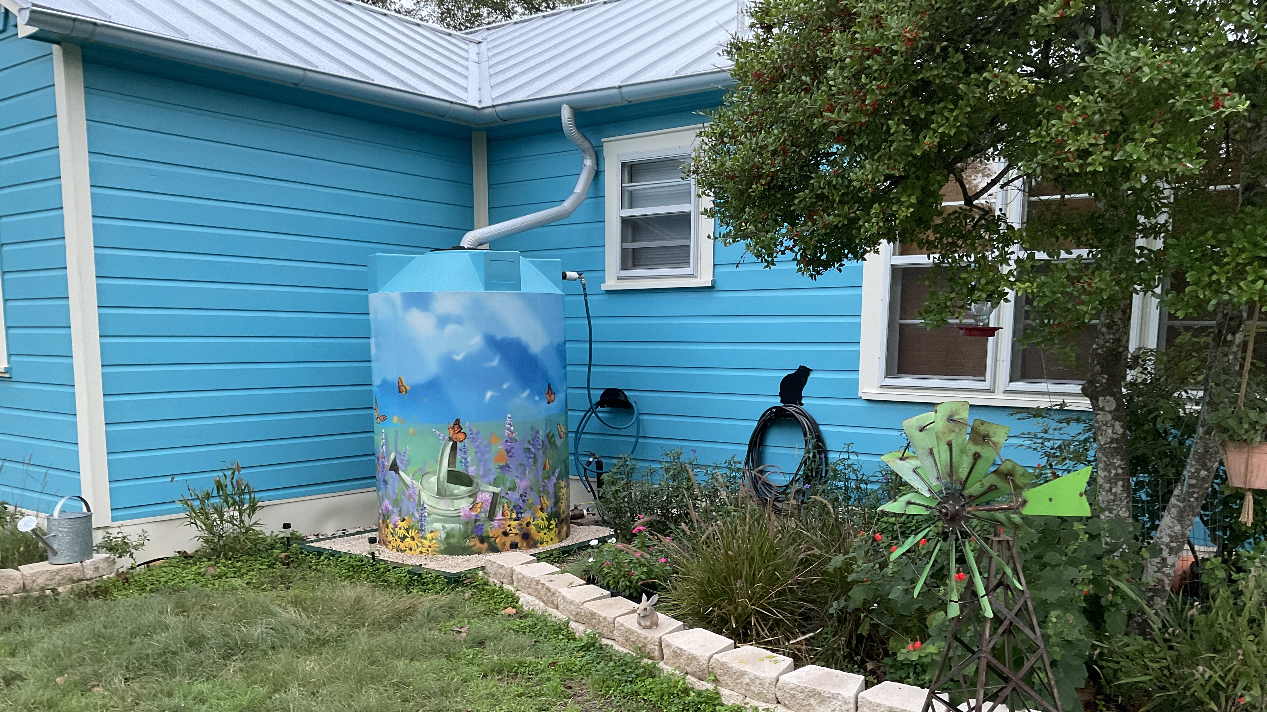 500-gallon wrapped cistern collecting from a 200 square-foot rooftop. Fills with each 2-inches of accumulated rainfall.