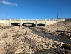 Excavation and armoring was performed under an existing TxDOT bridge pinch point within the project to maintain the bridge while addressing capacity and scour issues.