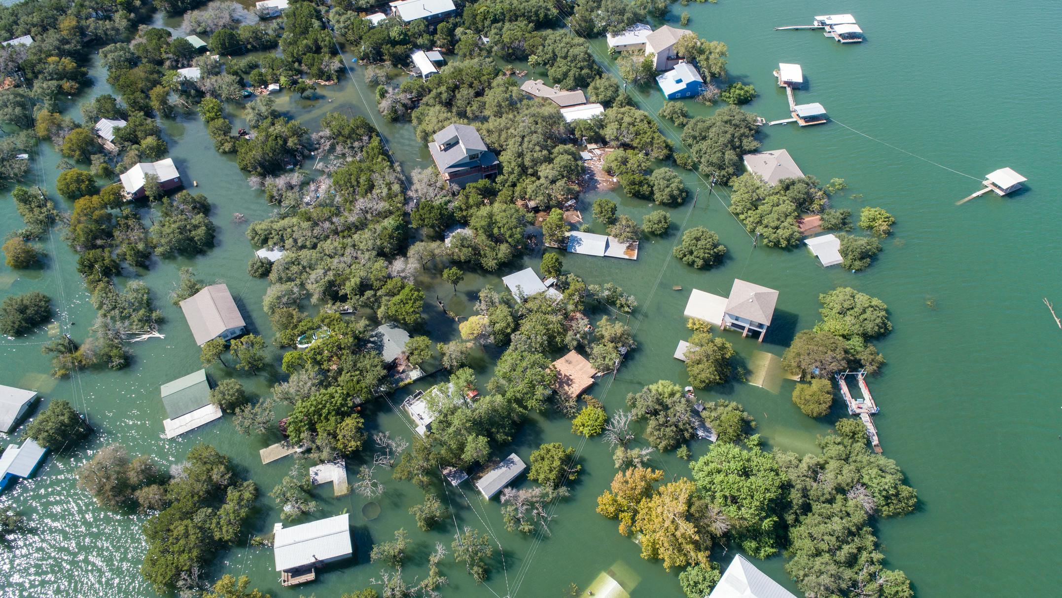 Aerial drone view entire neighborhood under water major flooding in Central Texas. Aerial drone view entire neighborhood under water - near Austin Texas at Lake Travis historic flooding of October 2018 causes evacuations and flooded homes. (Photo and caption credit: Bryan Roschetzky, Dreamstime)