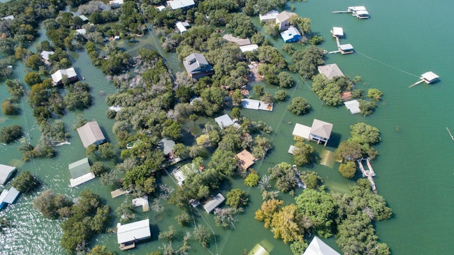 Aerial drone view entire neighborhood under water major flooding in Central Texas. Aerial drone view entire neighborhood under water - near Austin Texas at Lake Travis historic flooding of October 2018 causes evacuations and flooded homes. (Photo and caption credit: Bryan Roschetzky, Dreamstime)