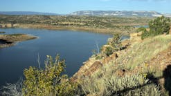 View of Abiquiu Lake, an Army Corps of Engineers reservoir in northern New Mexico, USA, with pinyon and juniper trees at dawn. View of Abiquiu Lake, an Army Corps of Engineers reservoir in northern New Mexico, USA, with pinyon and juniper trees at dawn.