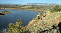 View of Abiquiu Lake, an Army Corps of Engineers reservoir in northern New Mexico, USA, with pinyon and juniper trees at dawn. View of Abiquiu Lake, an Army Corps of Engineers reservoir in northern New Mexico, USA, with pinyon and juniper trees at dawn.