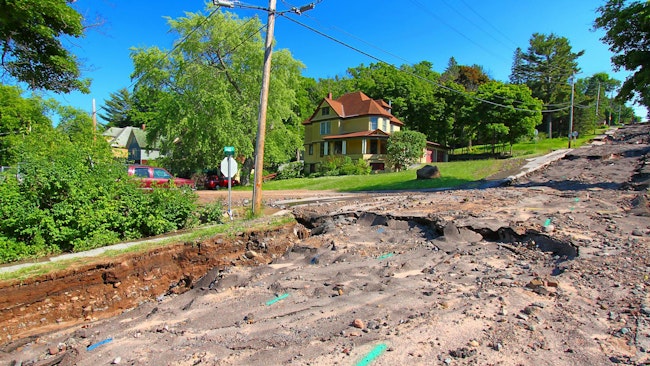 Houghton Michigan Flash Flood Damage. Houghton, Michigan, USA - June 18, 2018: Intense storm rainfall and flash flooding in June of 2018 caused property damage and completely washed out Agate Street in the town of Houghton, Michigan.