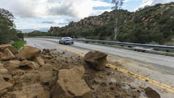 Rockslide Roadway Los Angeles. Los Angeles, California, USA - February 18, 2017: Car passing storm caused rock slide on Santa Susana Pass Road in the San Fernando Valley. Rockslide Roadway Los Angeles. Los Angeles, California, USA - February 18, 2017: Car passing storm caused rock slide on Santa Susana Pass Road in the San Fernando Valley.