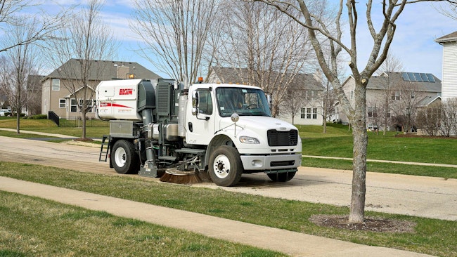 Elgin RegenX1 sweeping a street in a residential neighborhood.