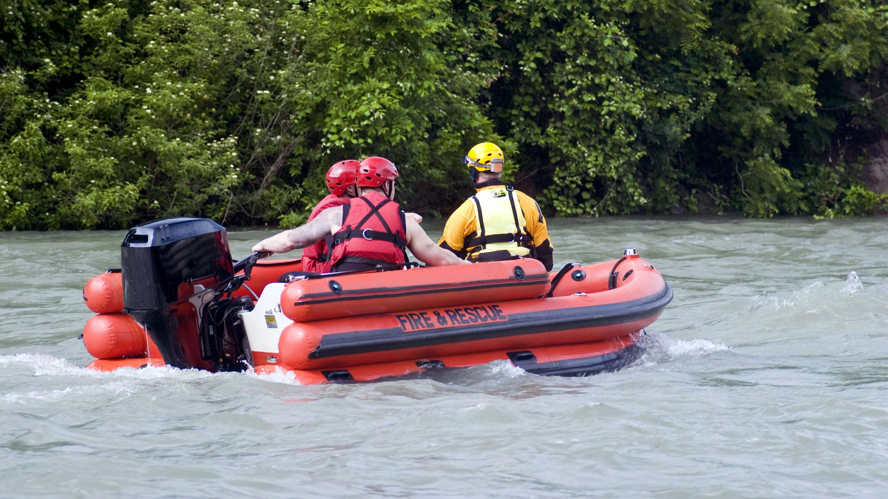Rescue Team. Fire and Rescue emergency team conducting a practice drill on a river after several days of heavy rain.