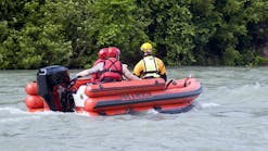 Rescue Team. Fire and Rescue emergency team conducting a practice drill on a river after several days of heavy rain. Rescue Team. Fire and Rescue emergency team conducting a practice drill on a river after several days of heavy rain.