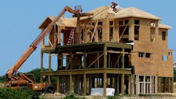 Construction workers building a beachfront home at the Outer Banks of North Carolina Construction workers building a beachfront home at the Outer Banks of North Carolina